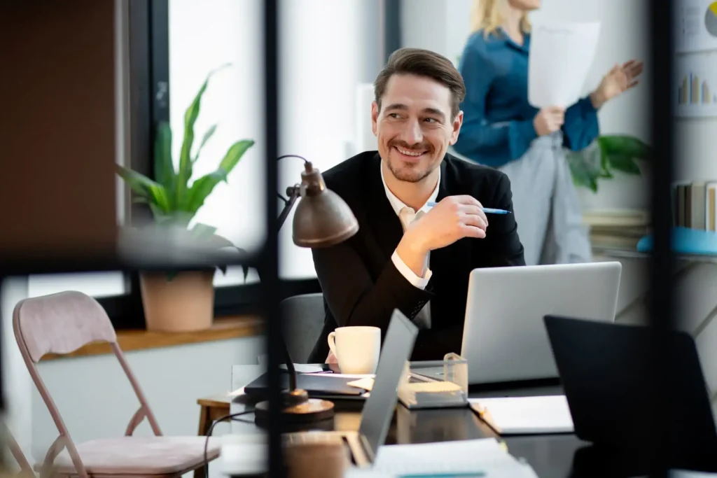 medium shot smiley man desk 1 1