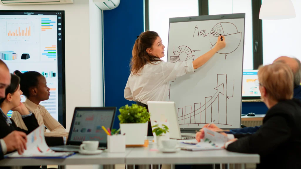 focused team leader presenting marketing plan interested multiracial coworkers serious speaker boss executive business trainer explaining development strategy motivated mixed race employees scaled